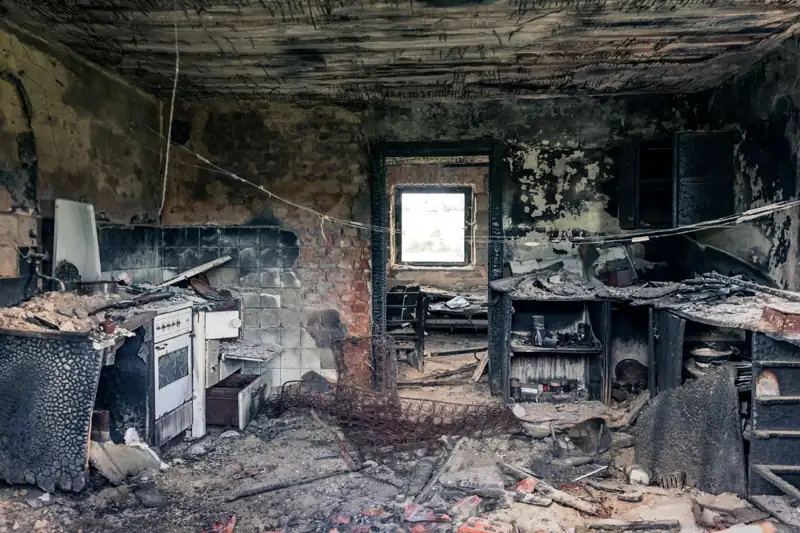 Fire and smoke damage inside a burned-out kitchen